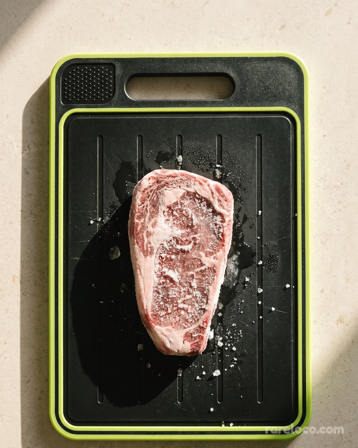 Steak on the defrosting side of the board