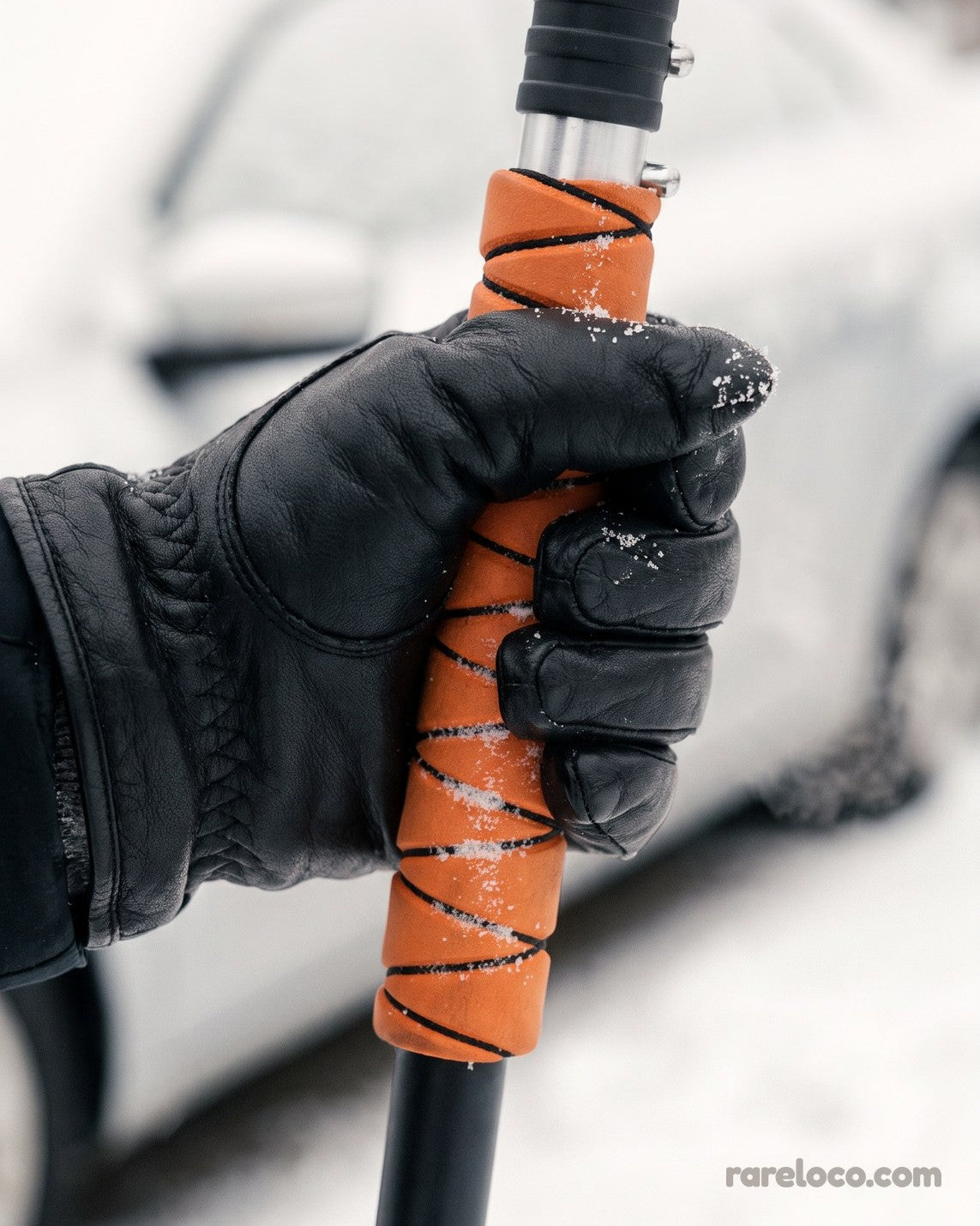 Gloved hand gripping the foam handle